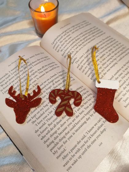 A festive flatlay of my red glitter ornaments, including a reindeer, candy cane, and stocking. These make wonderful, lasting additions to your holiday collection.