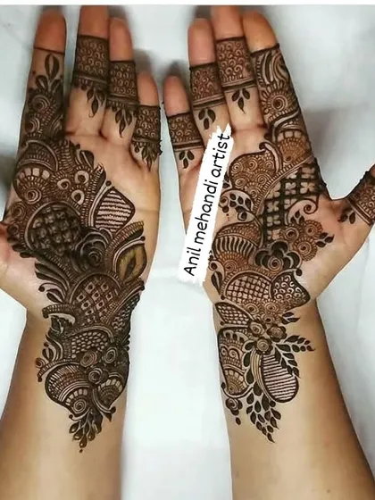 A great example of modern party mehandi. The designs are different on each hand, combining geometric patterns with flowing, Arabic-style elements.