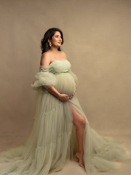 A vision in soft green. This gown, with its delicate layers and off-shoulder design, is one of my favorites for creating a romantic, garden-like feel in the studio.