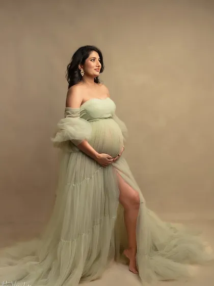 A vision in soft green. This gown, with its delicate layers and off-shoulder design, is one of my favorites for creating a romantic, garden-like feel in the studio.