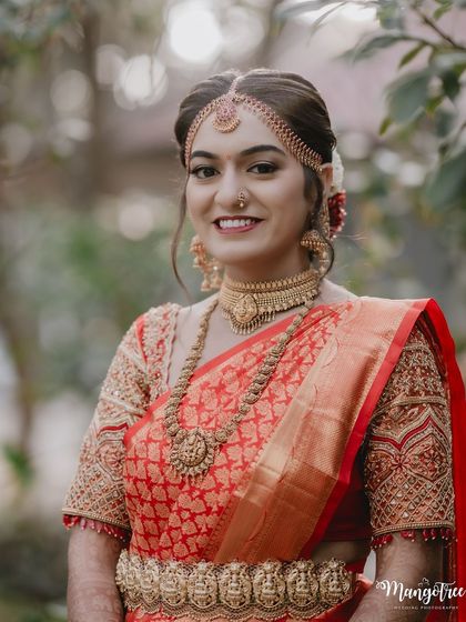 A beautiful close-up portrait of Tanu, highlighting her flawless skin and the intricate details of her bridal jewellery.