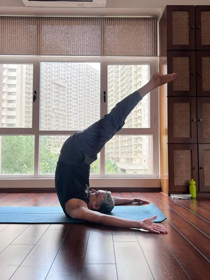 A student joyfully holds a pose for our International Yoga Day celebration. This image is a beautiful expression of what joy on a yoga mat looks like.