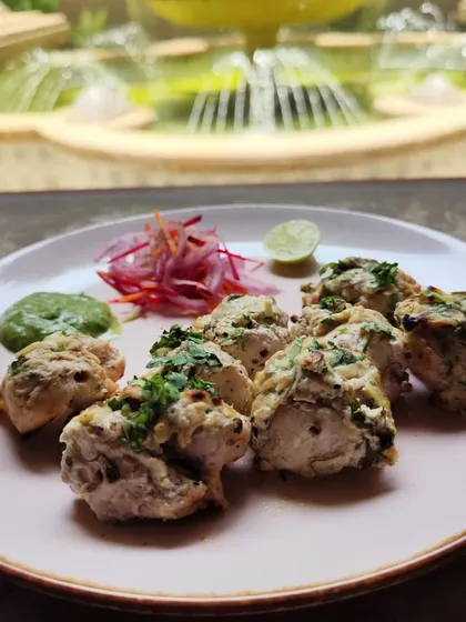 The Chicken Chaat E Chaman is a tangy and flavorful starter. Tender pieces of chicken are tossed in a chaat-style masala, served with fresh onions and chutney.