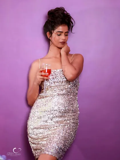 A full-length shot that showcases the stunning silver sequin dress. The pose is elegant and timeless.