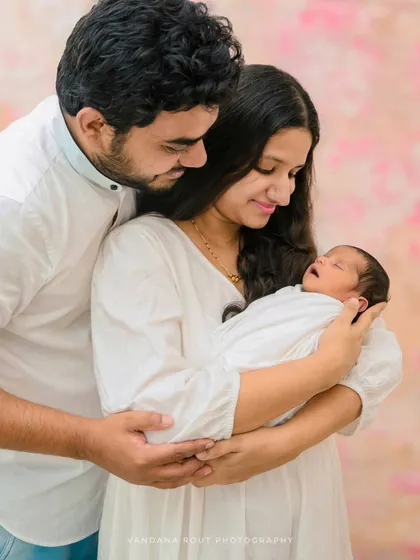 A slightly different angle showing the parents' loving embrace around their sleeping newborn. My goal is to provide a variety of beautiful shots from your first family session.