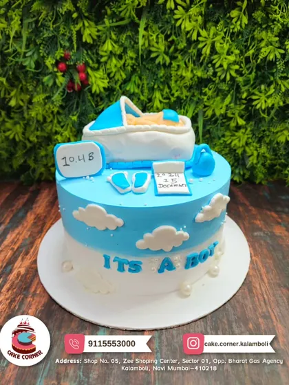 "It's a Boy!" A cute baby shower cake with a fondant baby in a bassinet. The blue and white cloud theme is perfect for welcoming a little prince.