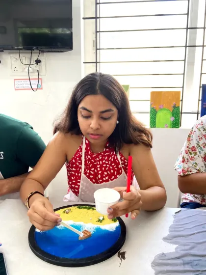 A participant carefully adds details to her resin beach art. The process is both creative and relaxing, allowing you to get lost in the moment.