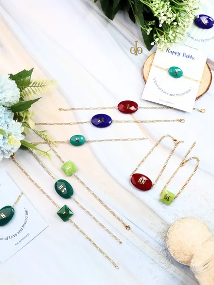 A flat lay of our semi-precious stone Rakhis, displayed with their "Happy Rakhi" backing cards.