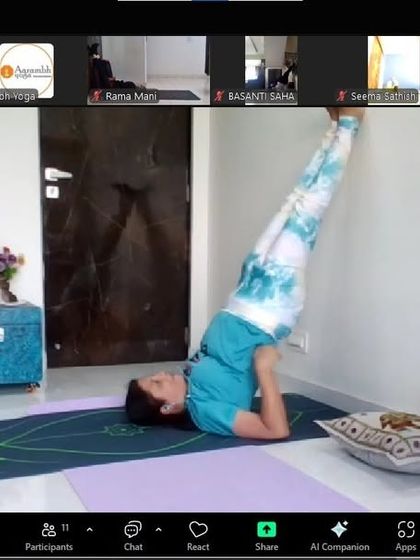 A student practicing a supported Sarvangasana (Shoulder Stand) against a wall during our Thyroid Yoga Workshop. This inversion is highly beneficial for stimulating the thyroid gland, and we teach safe ways to practice it.