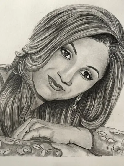 A completed A4 pencil portrait of a woman with flowing hair, based on a professional photograph. This sketch makes a sophisticated and personal piece of art.