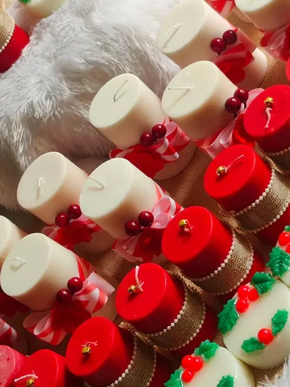 A collection of New Year and Christmas gifts, including pillar candles and festive soaps.