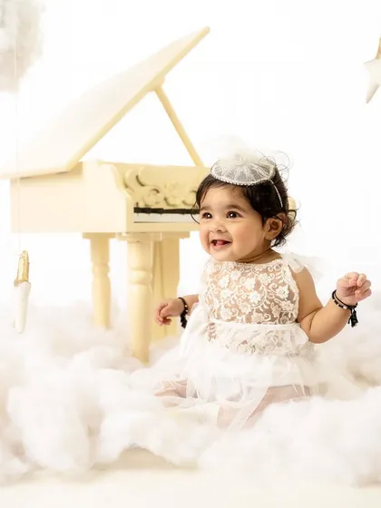 A heavenly smile from this little angel. The "piano in the clouds" setup is one of my most requested for sitter and milestone sessions.
