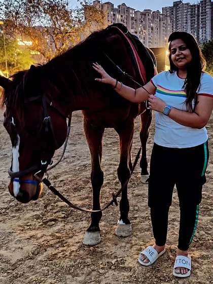 A relaxed portrait of a woman gently petting her horse. Our horses are calm and responsive, allowing for natural and interactive photoshoots.