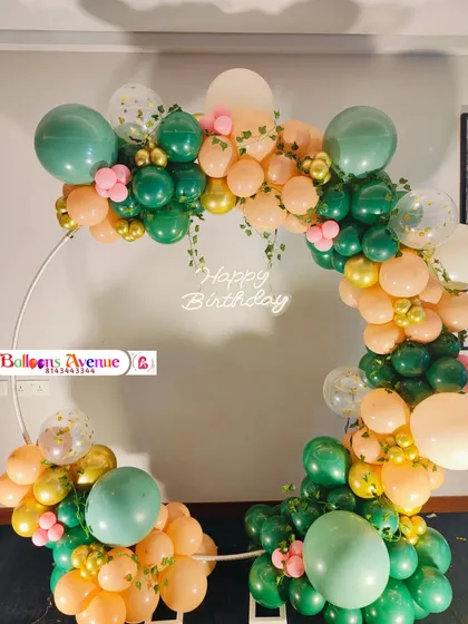A clear, frontal shot of the elegant green and peach birthday ring.