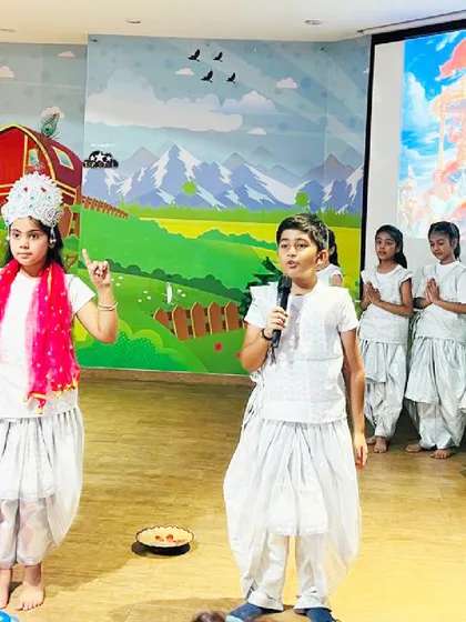 Children dressed in traditional attire perform a play about Lord Krishna. Our stage area provides the perfect platform for kids to showcase their talents during festive shows.