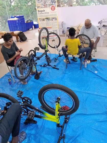 An overhead view of our bicycle repair station during a summer camp. Participants get dedicated space and tools to work on their bikes under the guidance of our experienced mentors.