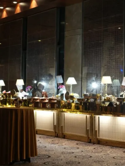 A beautifully arranged buffet line for a formal dinner. We ensure that even the catering setup is elegant, with proper lighting and tablecloths that match the event's decor.