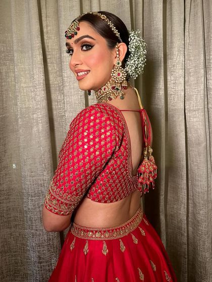 A modern twist on a classic red look. The shimmery bronze eyes add a contemporary feel to the traditional bridal ensemble.