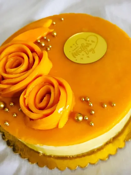 This mango cheesecake is a tribute to Mom, decorated with rosettes made from fresh mango slices and a "Happy Mother's Day" topper. It's as beautiful as it is delicious.