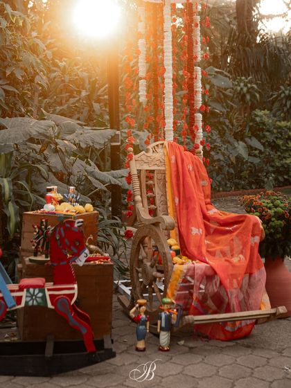 This photo corner was designed around a beautiful dupatta with Gowri motifs from the bride's mother. We paired it with an antique chair, old trunks, and Channapatna crafts to create a nostalgic and picture-perfect setting.