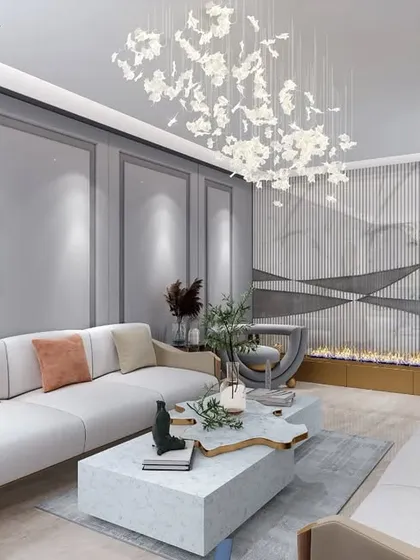 This wide shot captures the full elegance of the living room, with its flowing chandelier and sophisticated color palette. The design balances neutral tones with pops of blue and orange for a refined look.