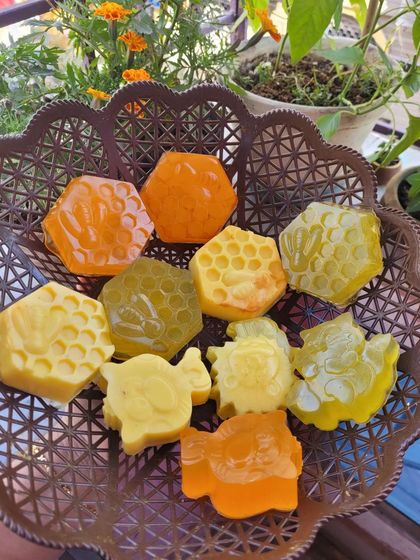A basket full of my yellow and orange toned soaps, likely containing ingredients like lemon, orange, and turmeric.