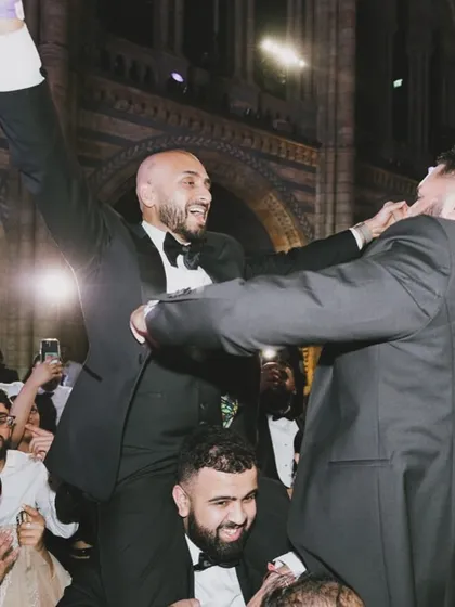 Pure celebration. The groom on his friend's shoulders in the middle of a packed dance floor. These are the moments we live for, made possible by the energy we build.