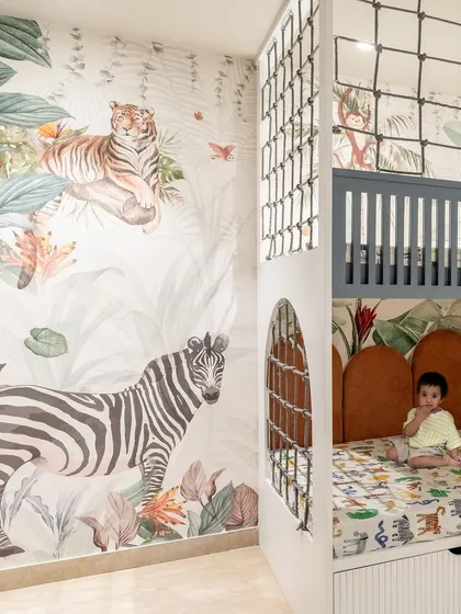 Designing for children is about sparking imagination. This jungle-themed bedroom features a custom bunk bed that doubles as a play area, with integrated storage in the steps. It's a fun, vibrant, and functional space designed to grow with the child.