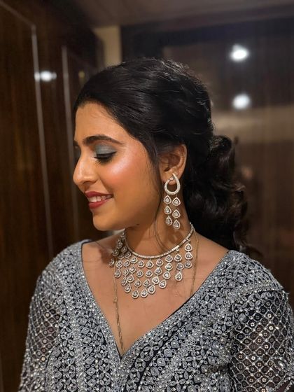 A side profile of our client, showing off her elegant makeup and hairstyle. The soft, cascading ponytail is both modern and timeless, perfect for any special occasion.