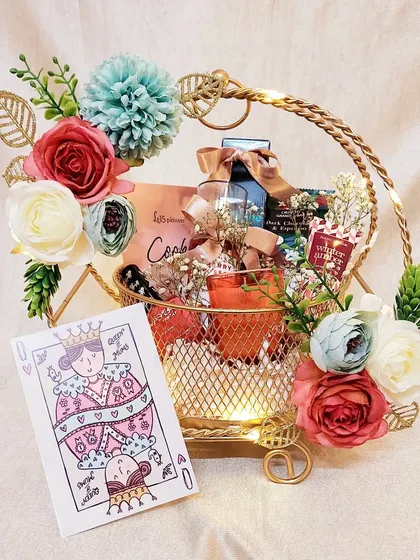 This elegant metal basket hamper was part of my Mother's Day collection. It features a "Queen of my Heart" card and a curated selection of teas, cookies, and self-care items.