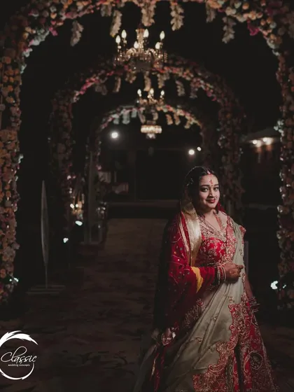 A bride's moment in the spotlight. This tunnel of floral arches and chandeliers, which I designed for a resort wedding, also serves as a stunning backdrop for bridal portraits.