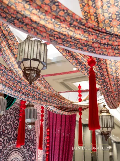 A ceiling of texture and tradition. I used printed fabrics and hanging Moroccan-style lanterns to create a rich and atmospheric overhead decor for a themed event.