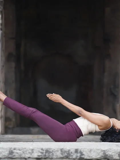 This reclining posture, Uttana Padasana, requires core strength and stability. It is a physical reminder that true growth comes from building a strong foundation, one small step at a time, even when it feels challenging.
