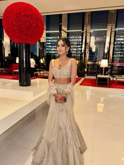 This full-length shot shows how the entire look comes together. The glistening couture, the sharp makeup, and the elegant hairstyle create a truly unforgettable cocktail look.