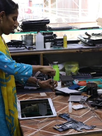 One of our skilled community members works on repairing a tablet. We promote the idea that anyone can learn to fix things, and our workshops often feature local repair professionals sharing their expertise.