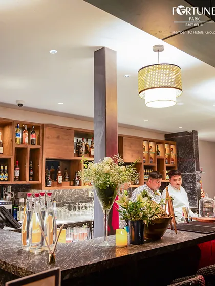 The rooftop bar at Nakshatra, fully stocked and ready for the evening. The warm lighting and elegant design create a welcoming atmosphere.
