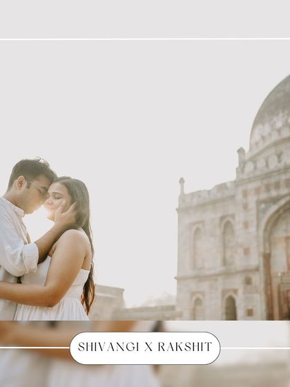 Bathed in the soft glow of the sun, this couple shares an intimate moment with a classic Delhi monument in the background, creating a dreamy and romantic pre-wedding photograph.