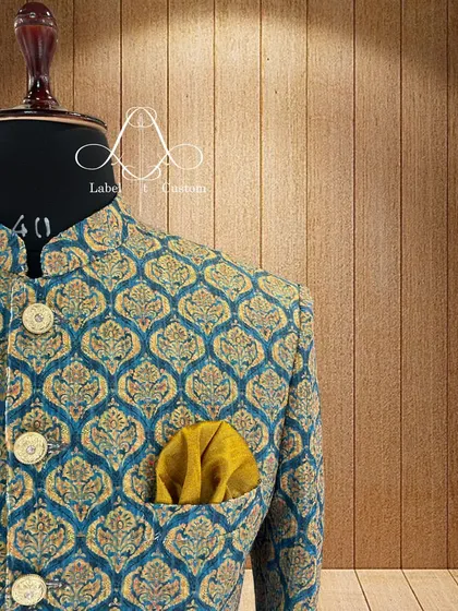 A closer look at the teal and gold brocade Bandhgala. You can see the texture of the fabric and the detail in the woven pattern. I source high-quality materials to ensure every garment not only looks good but feels luxurious.