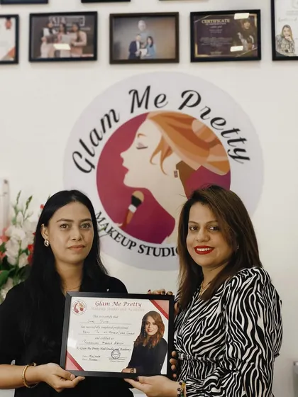 Handing over a certificate to another successful student. Her hard work and talent are sure to take her far in her new career.