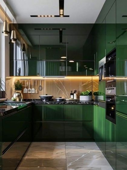 A bold and luxurious kitchen design featuring emerald green high-gloss cabinets. The look is elevated with a brass-toned backsplash and hardware, creating a dramatic and sophisticated culinary space.