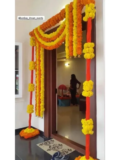Even a simple doorway can be transformed for a home Haldi ceremony with traditional marigold torans and hangings.