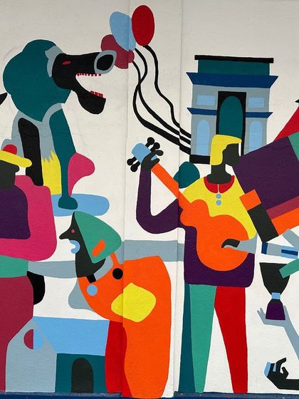 A detail from the Wall Art Festival mural, showing a blend of French and Indian cultural icons like the Eiffel Tower and a poodle.