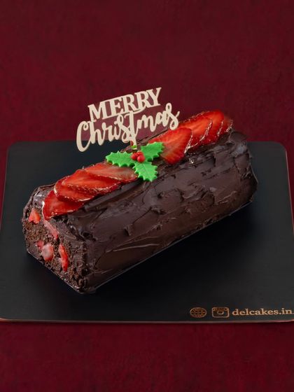 Our Traditional Chocolate Strawberry Yule Log is a festive masterpiece. It's decorated with fresh strawberries and a "Merry Christmas" topper, ready to be the star of your dessert table.