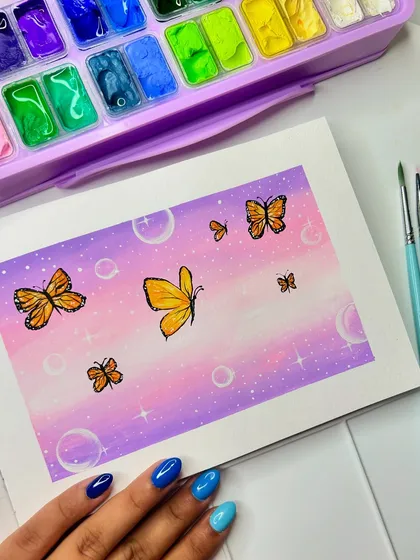 A dreamy painting of butterflies and bubbles against a pastel purple and pink sky. This was painted with gouache in my sketchbook.