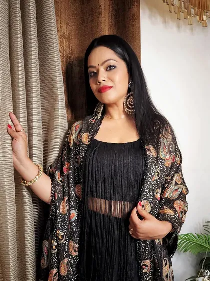 A black dress paired with a heavily embroidered and sequined shawl. This is a great way to add a festive touch to a simple outfit for a sangeet or cocktail party.