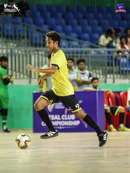 A player running with the ball, looking to start an attack.