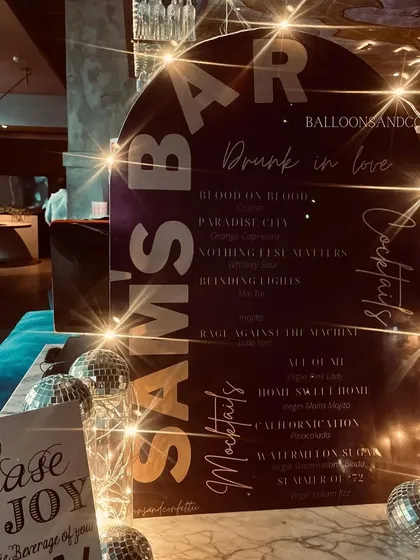 The custom bar menu for 'Sam's Bar', with cocktail and mocktail names inspired by famous rock songs.