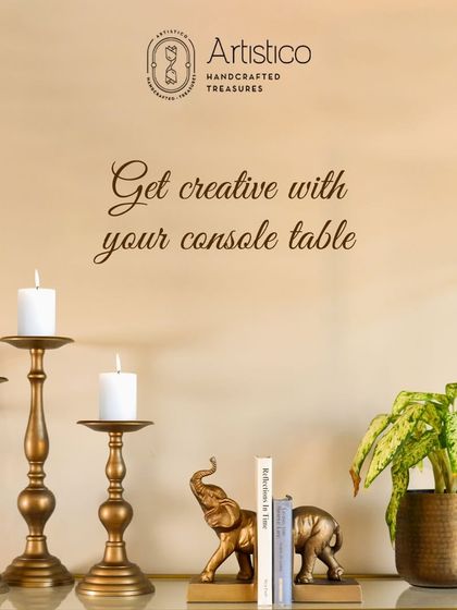 Get creative with your console table. This image shows how to style a table with my candle holders, elephant bookends, and a planter for a balanced look.