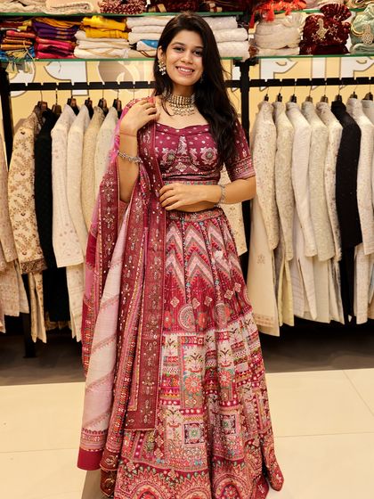 A smiling shot of a client in the maroon printed lehenga, showing how confident and happy you can feel in a rental.