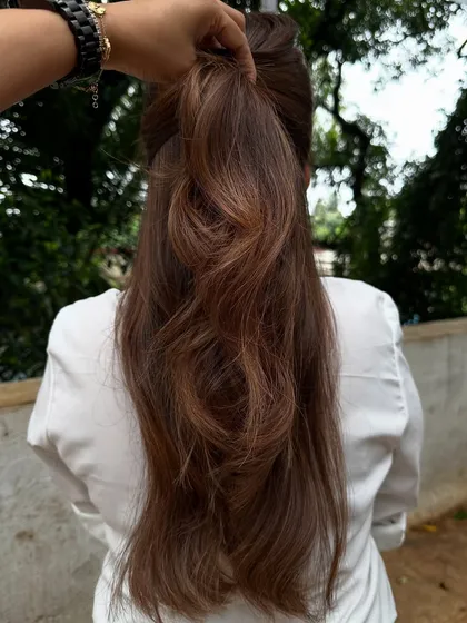 Getting ready for 'Ghar ki shaadi' (a home wedding). This client wanted a glamorous but natural look, so I gave her a rich color melt with soft waves, perfect for the occasion.